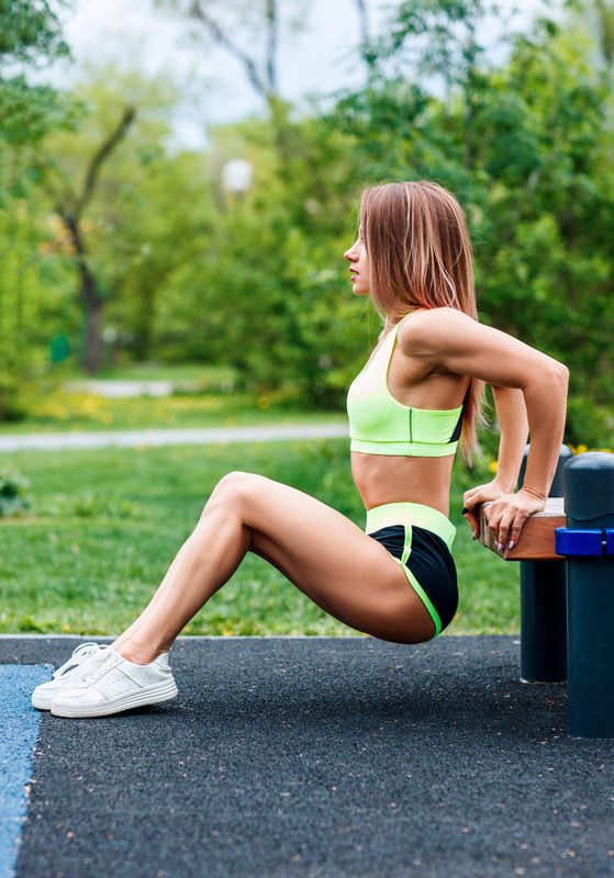 The Benefits of Exercise 2 Woman Doing Triceps Dip Exercise On City Street Bench.