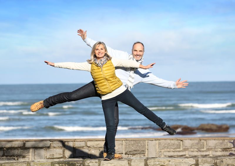 two people balancing on beach