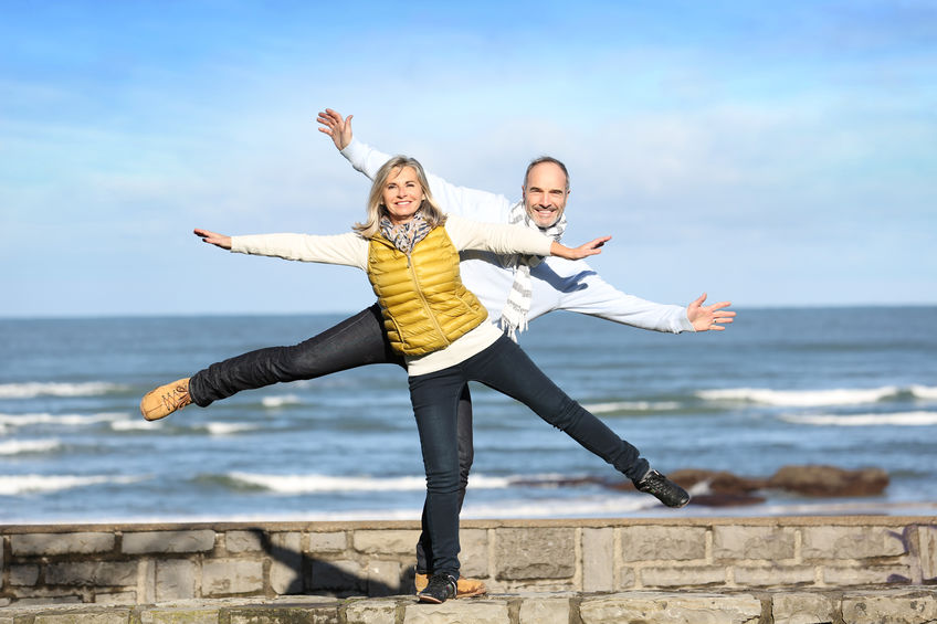 two people balancing on beach