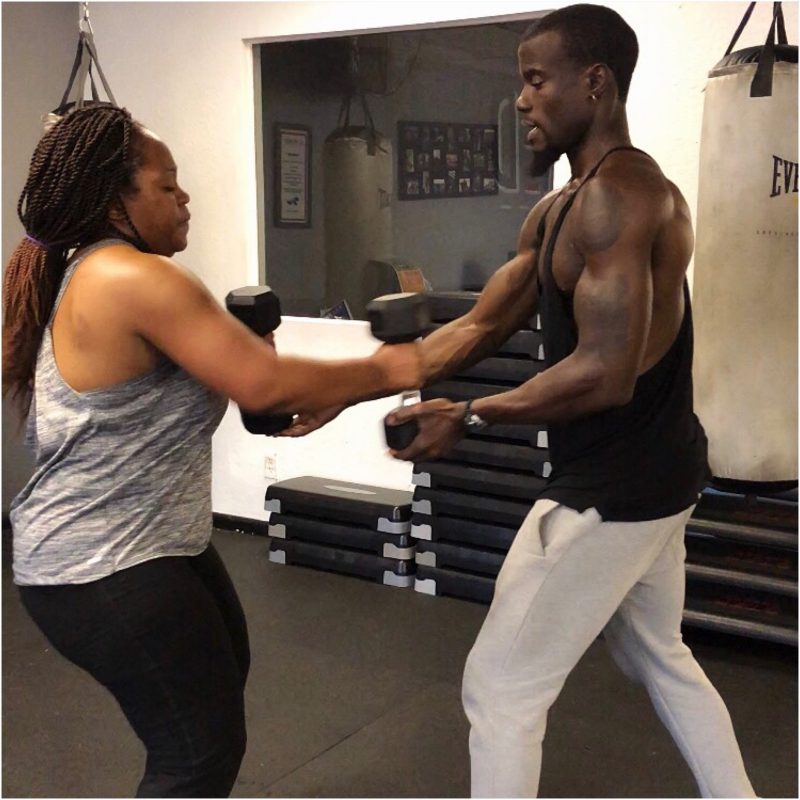 trainer working out with client