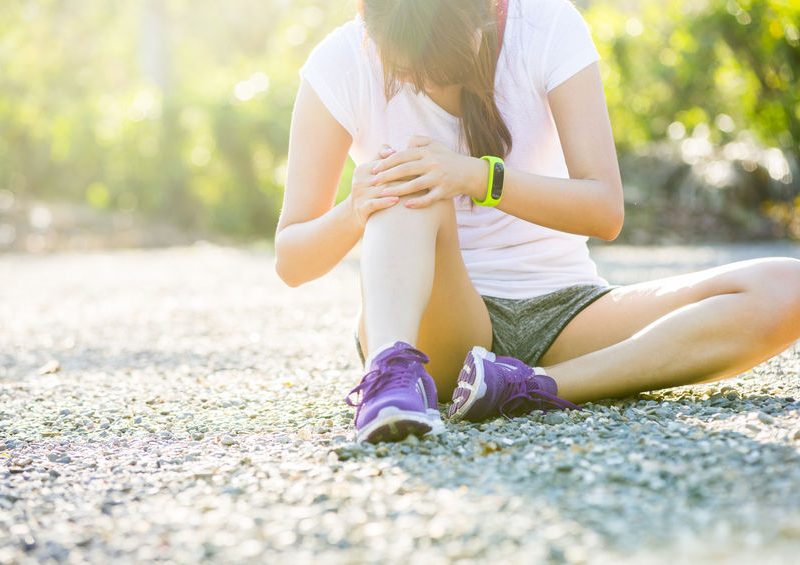 Runner Sport Knee Injury. Woman In Pain While Running In Park