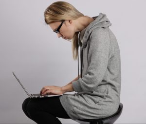 Bad Posture Effects.Female Student Using Laptop And Suffering From Back Pain