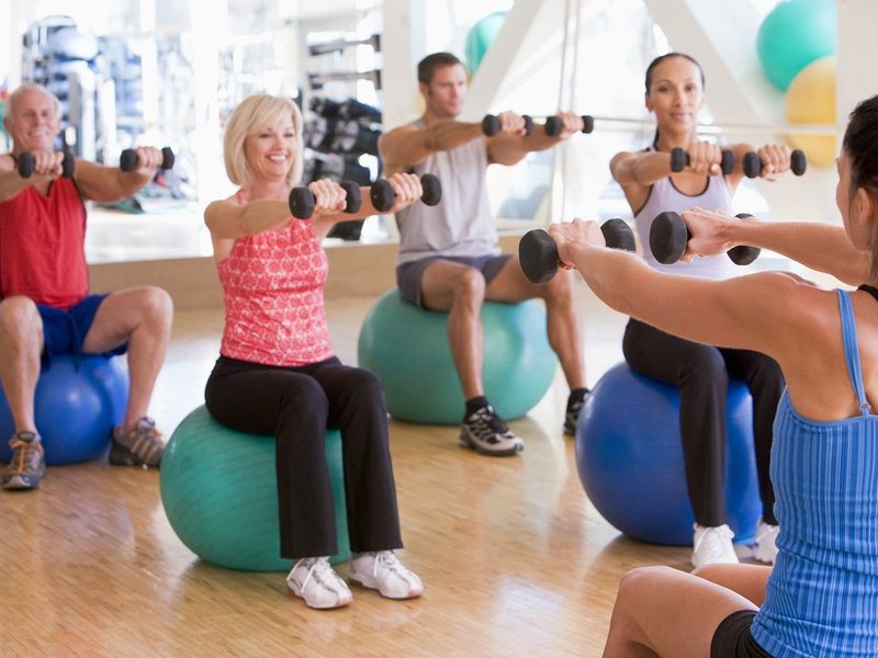 Instructor Taking Exercise Class At Gym