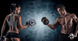 Athletic Man And Woman With A Dumbells.