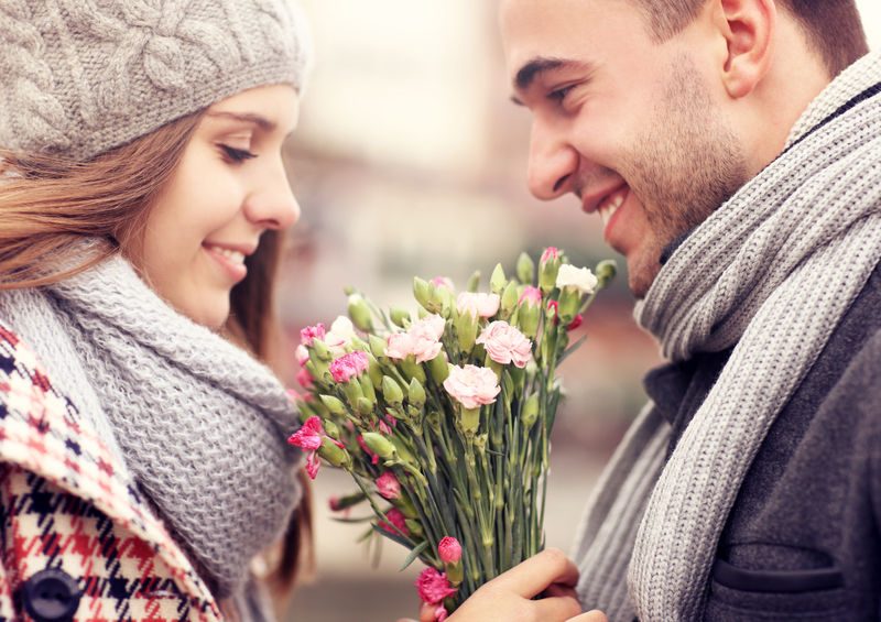 A Picture Of A Man Giving Flowers To His Lover On A Winter Day